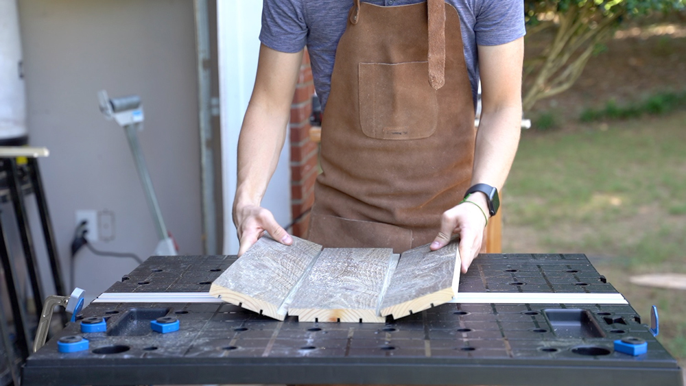 Man assembling three pieces of wood together. Man assembling three pieces of wood together.