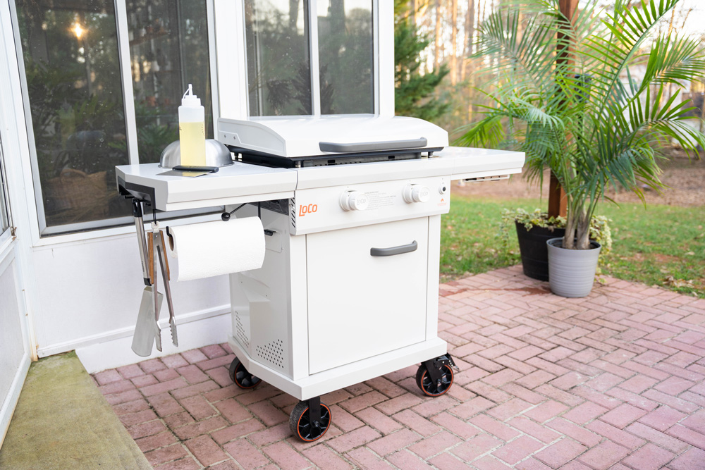 An outdoor grill on a brick patio. An outdoor grill on a brick patio.