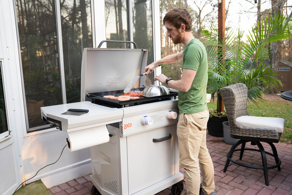 A man grilling on an outdoor grill. A man grilling on an outdoor grill.
