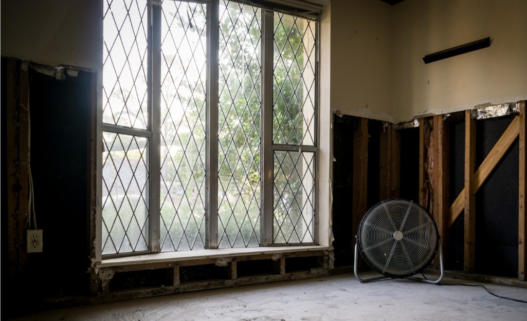 A blower fan dries a room after a water event.
