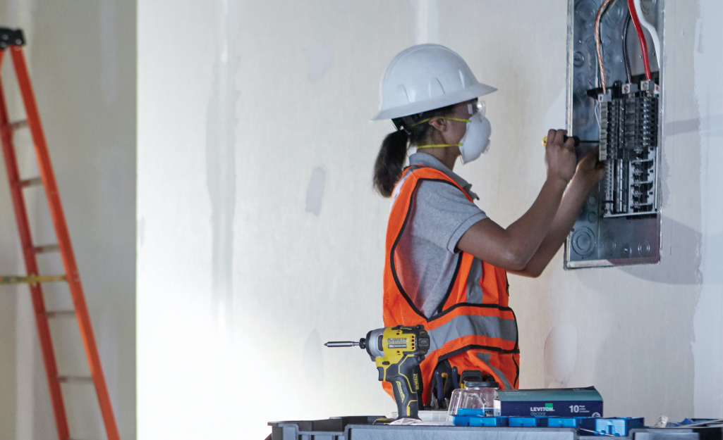 Worker Installs GFCI Circuit Breakers