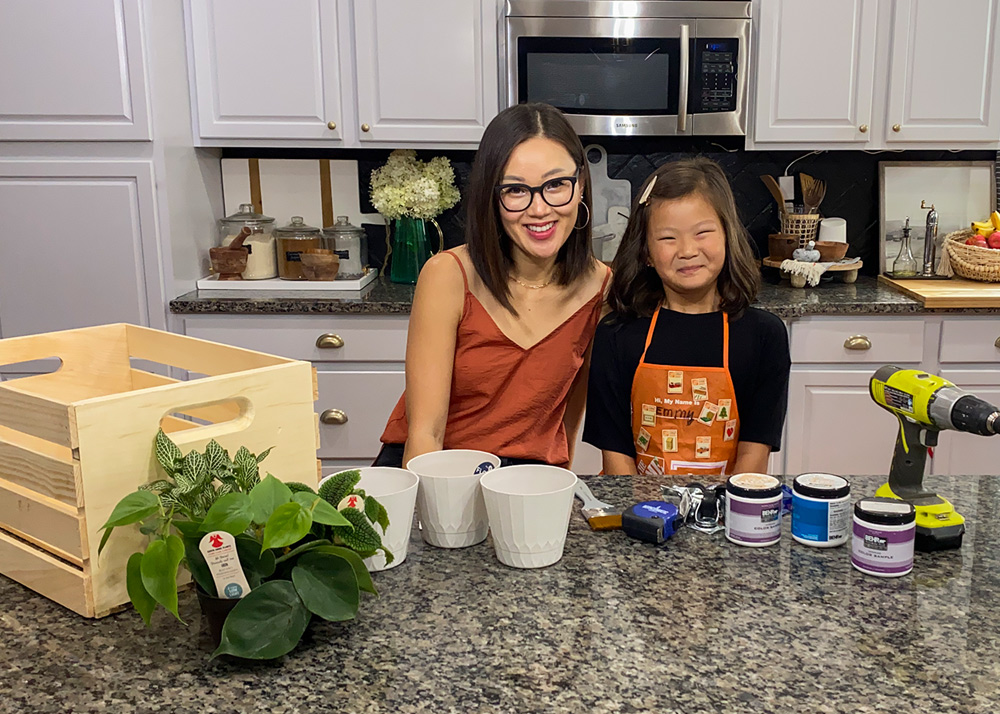 Mother and daughter standing in the kitchen with materials displayed