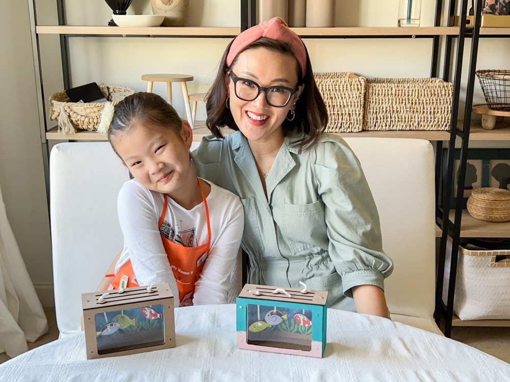 Young girl and her mom in front of their finished fish tanks