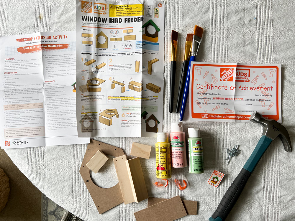 Crafting materials and tools needed for a Window Bird Feeder kit.