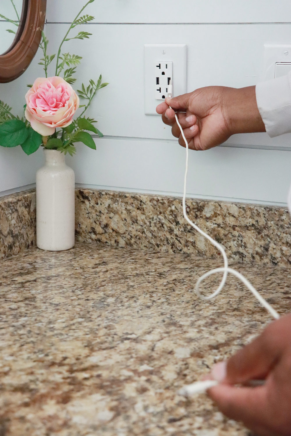 A man looking at the newly installed USB charging point.