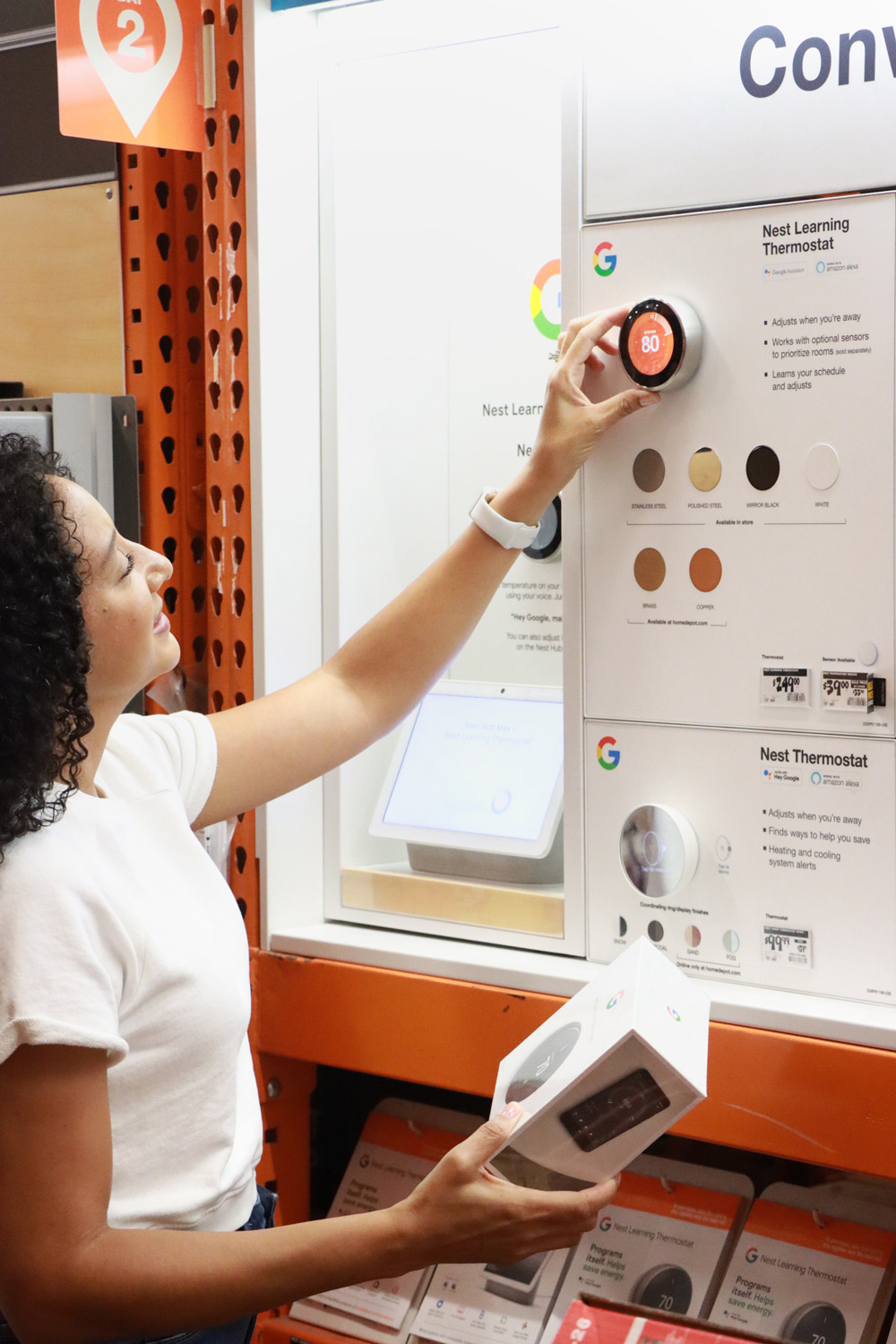 Woman testing the thermostat demo in The Home Depot.