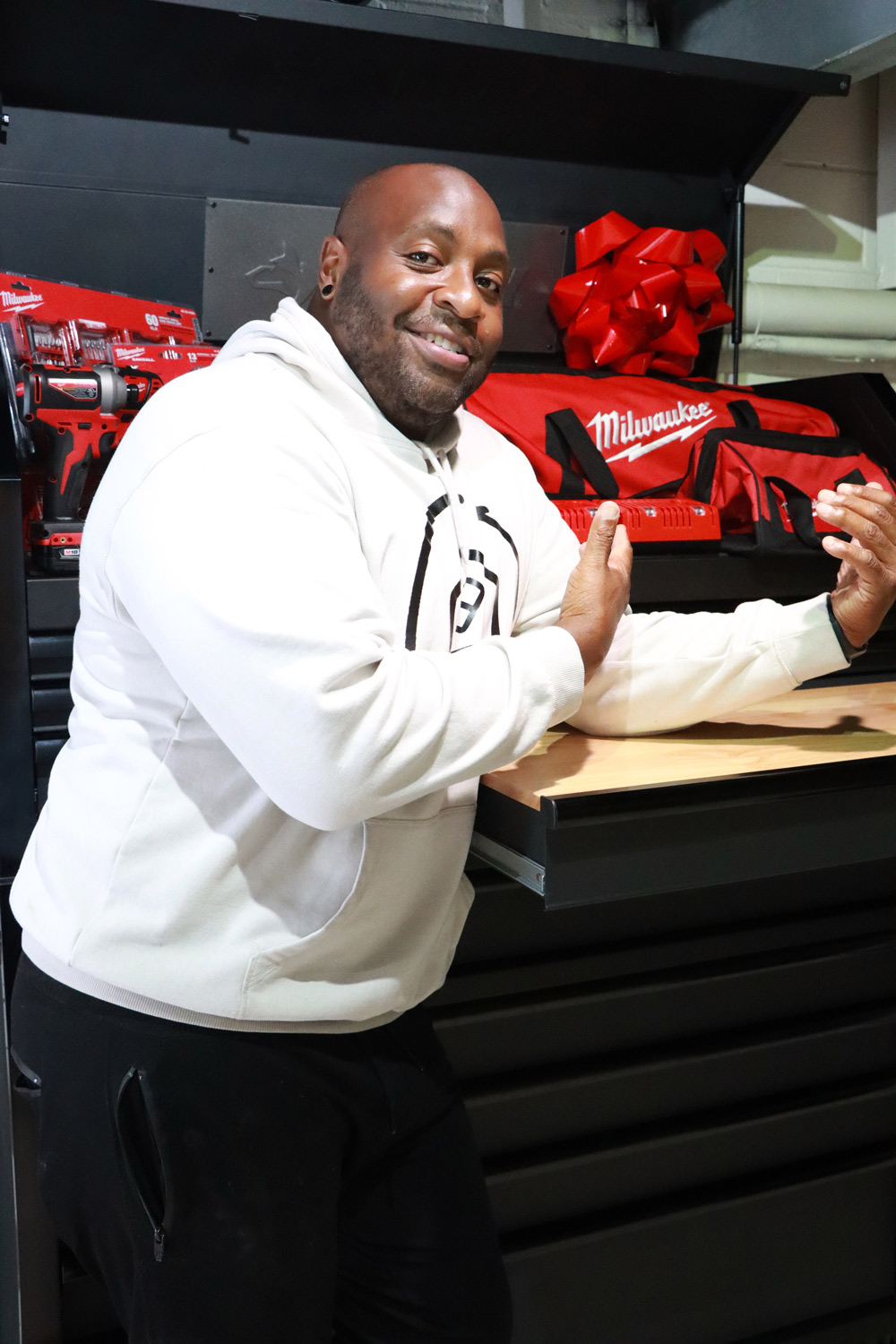 A man standing in front of his new tool chest.