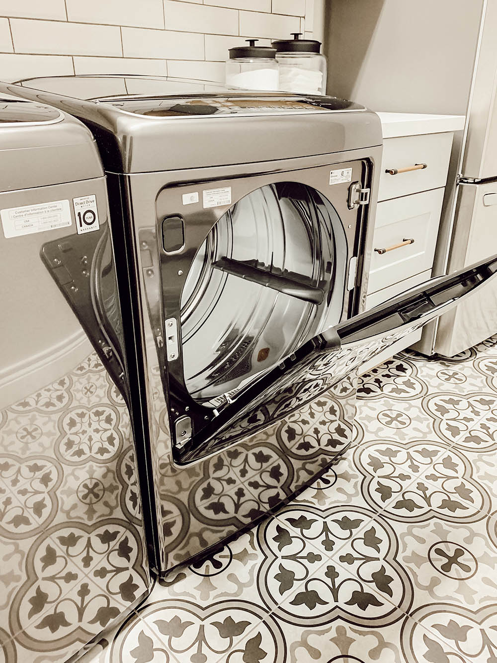 Exterior of the LG Smart Electric Dryer and mosaic titled flooring.