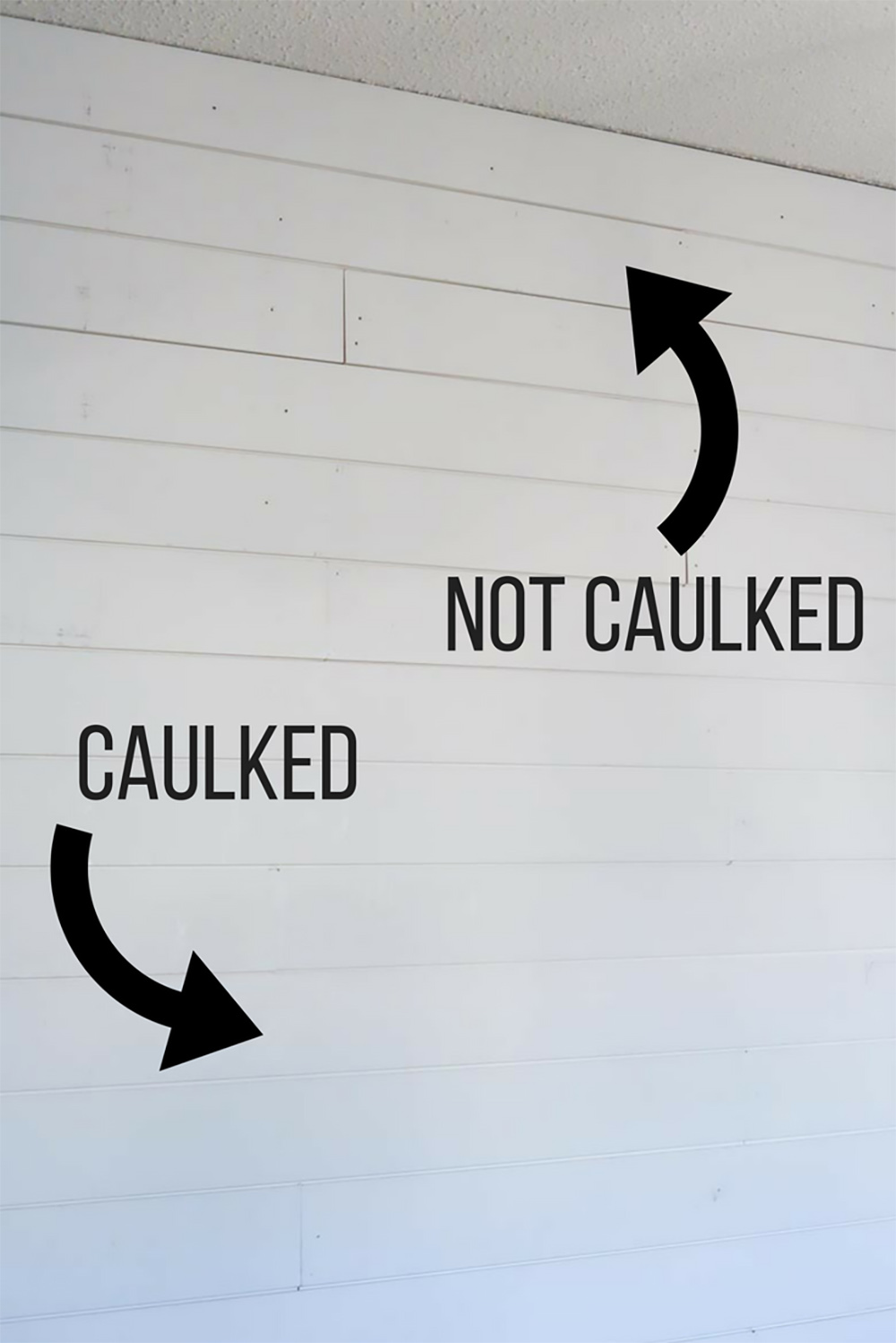 A white shiplap wall with arrows showing which area has been caulked and which area has not been caulked.