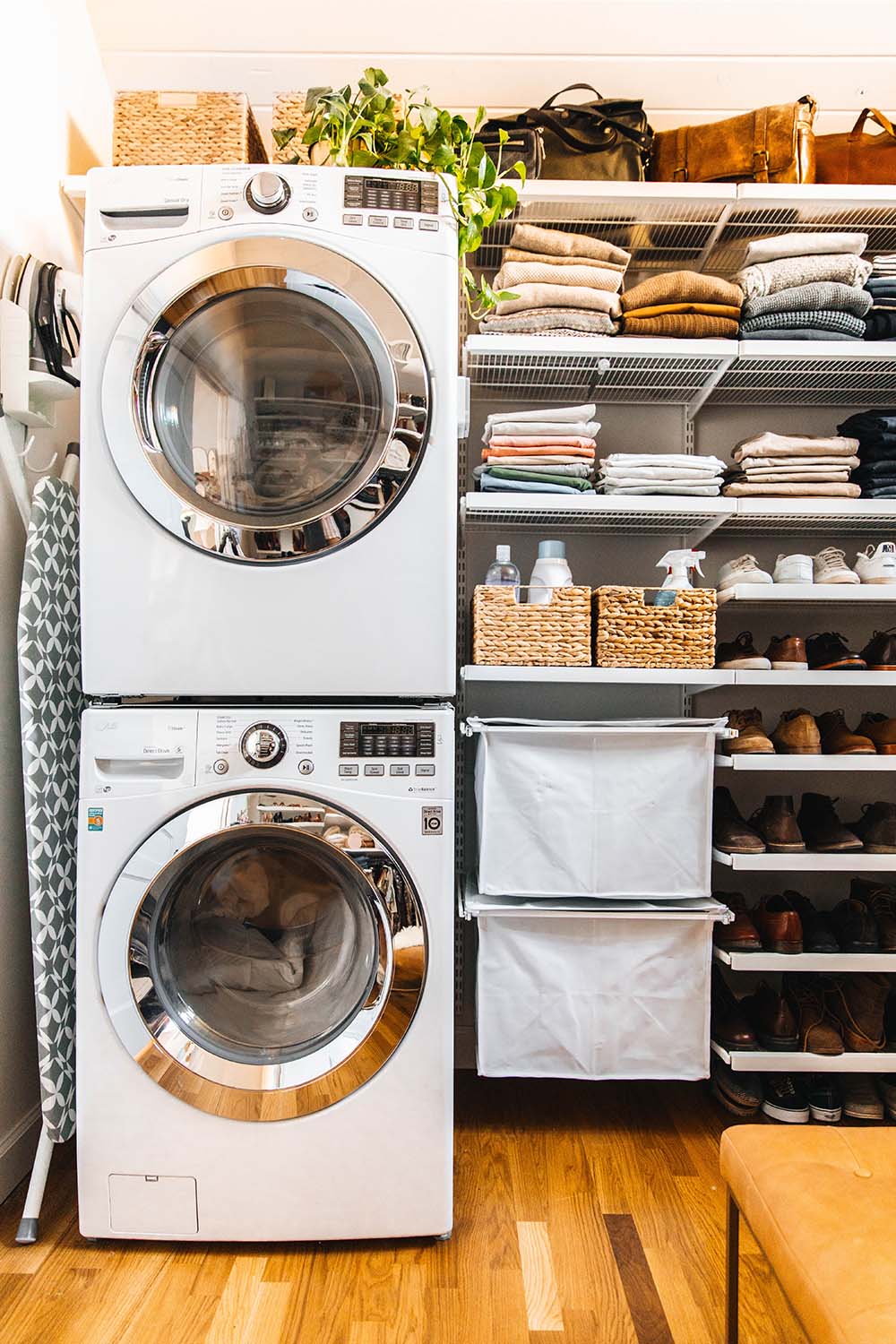 A pair of white front load LG laundry appliances stacked in a small laundry room.