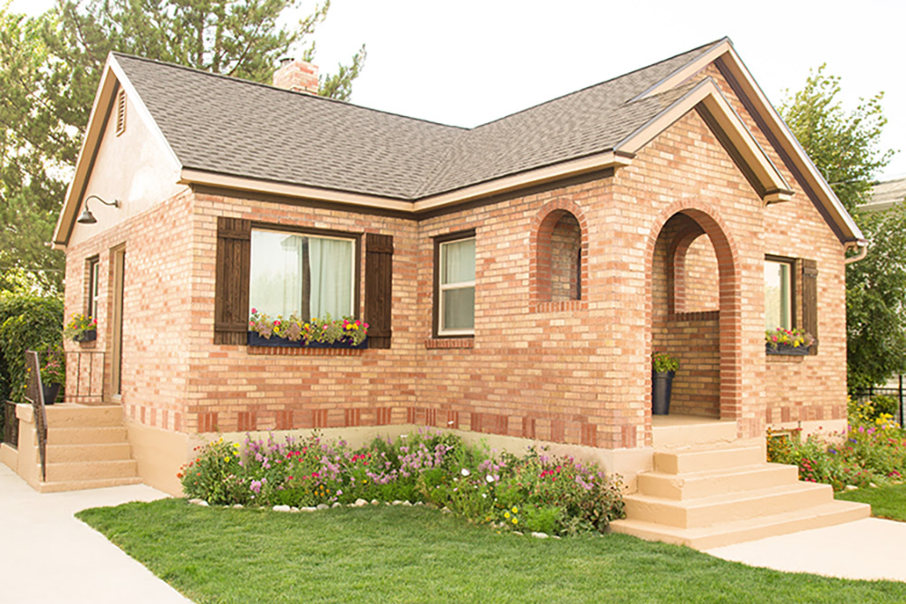 The front of a brick home with a new roof.