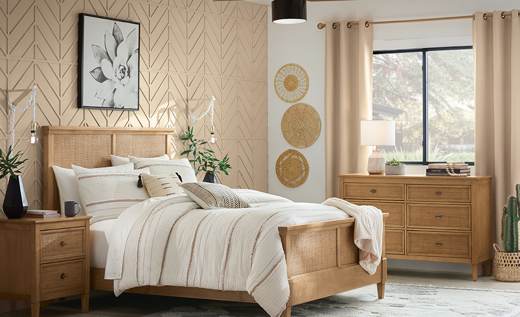 A bedroom accent wall with wallpaper. 