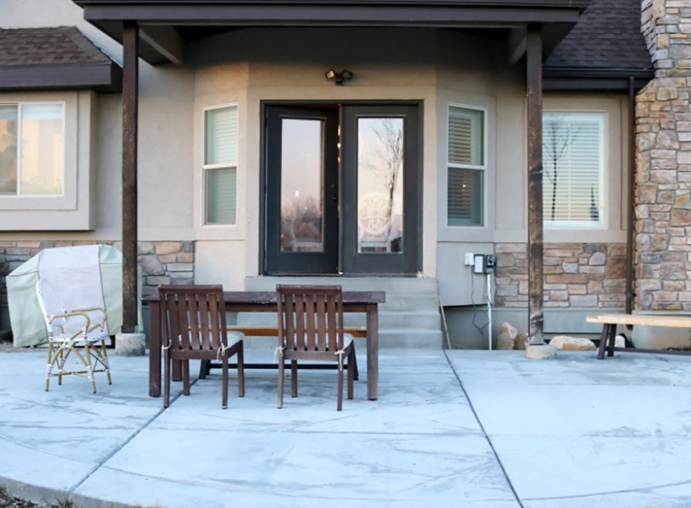 An patio with a brown outdoor dining table and chairs. An patio with a brown outdoor dining table and chairs.