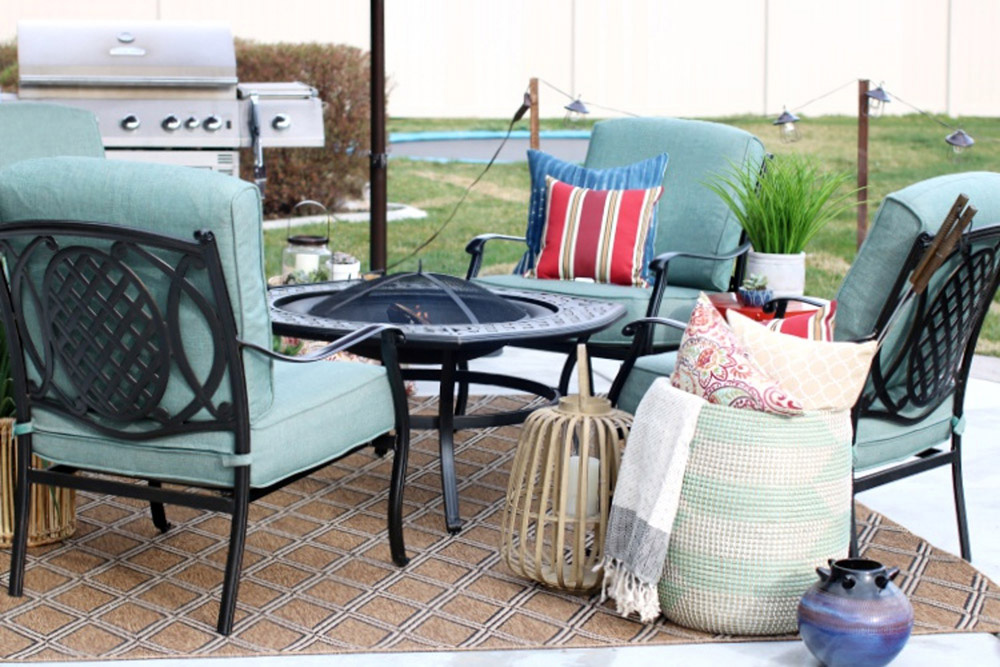 A patio area with a fire pit, outdoor seating, and a grill. A patio area with a fire pit, outdoor seating, and a grill.