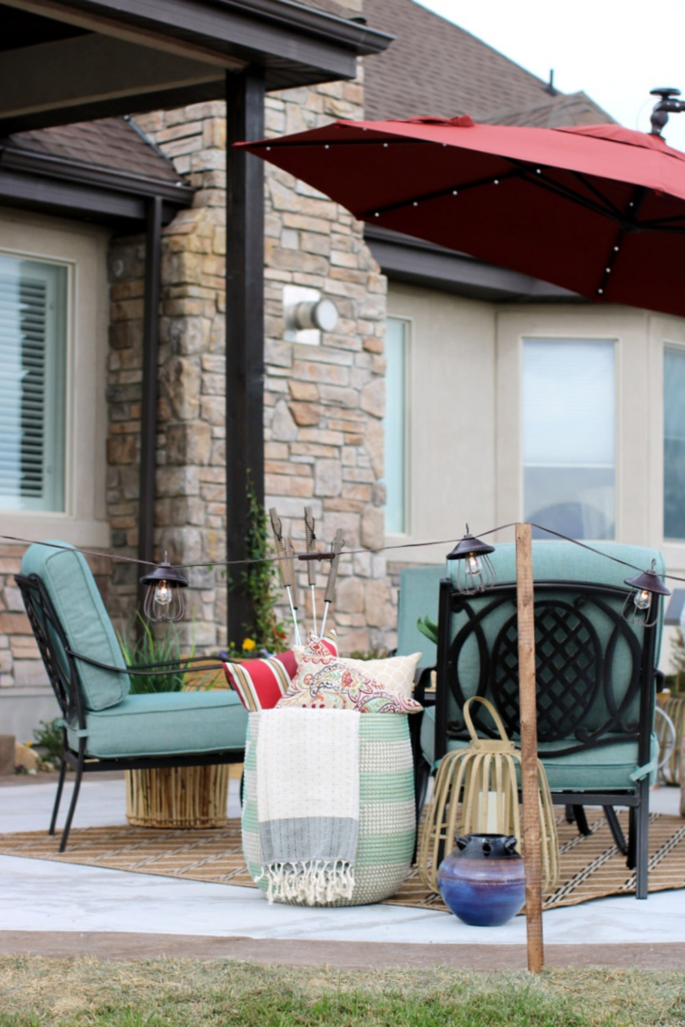 An outdoor seating area surrounded by bronzed cafe string lights. An outdoor seating area surrounded by bronzed cafe string lights.