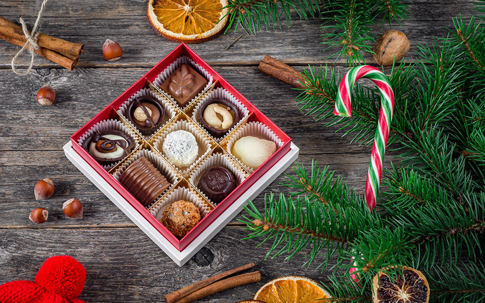 A box of chocolate candies on a table. A box of chocolate candies on a table.