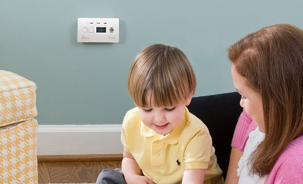 A carbon monoxide detector installed on a wall in a playroom. A carbon monoxide detector installed on a wall in a playroom.