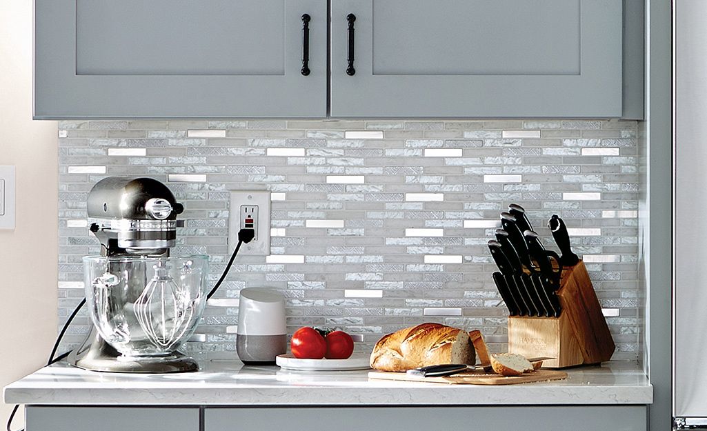 Silvery gray monochromatic tile is a great backsplash for gray cabinets.