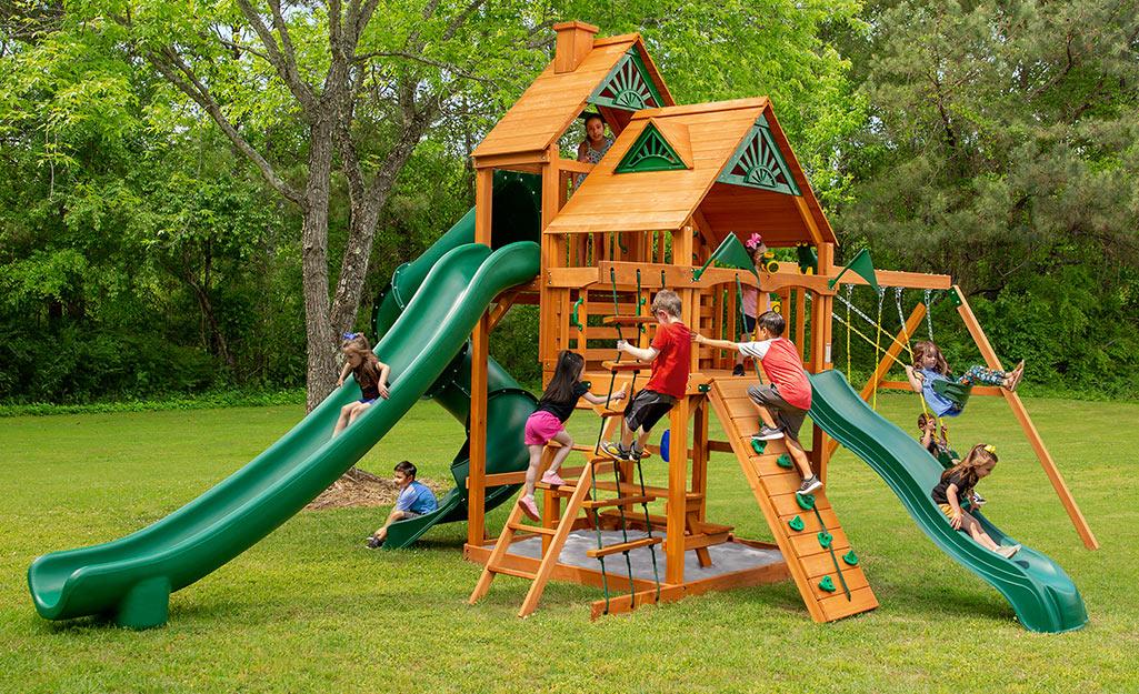 Children playing on a wood playset.