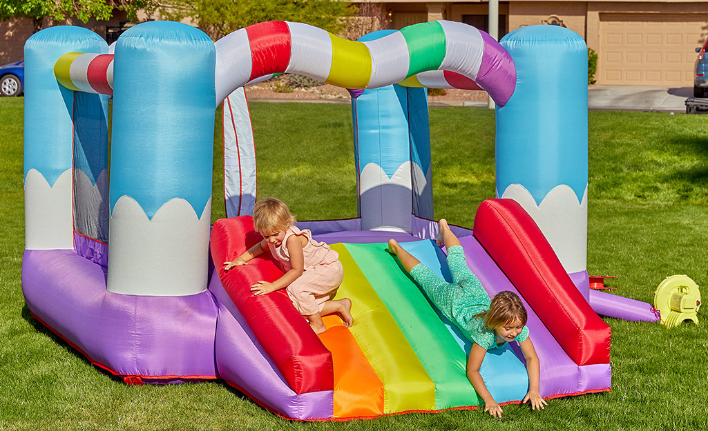 Children playing on an inflatable bounce house.