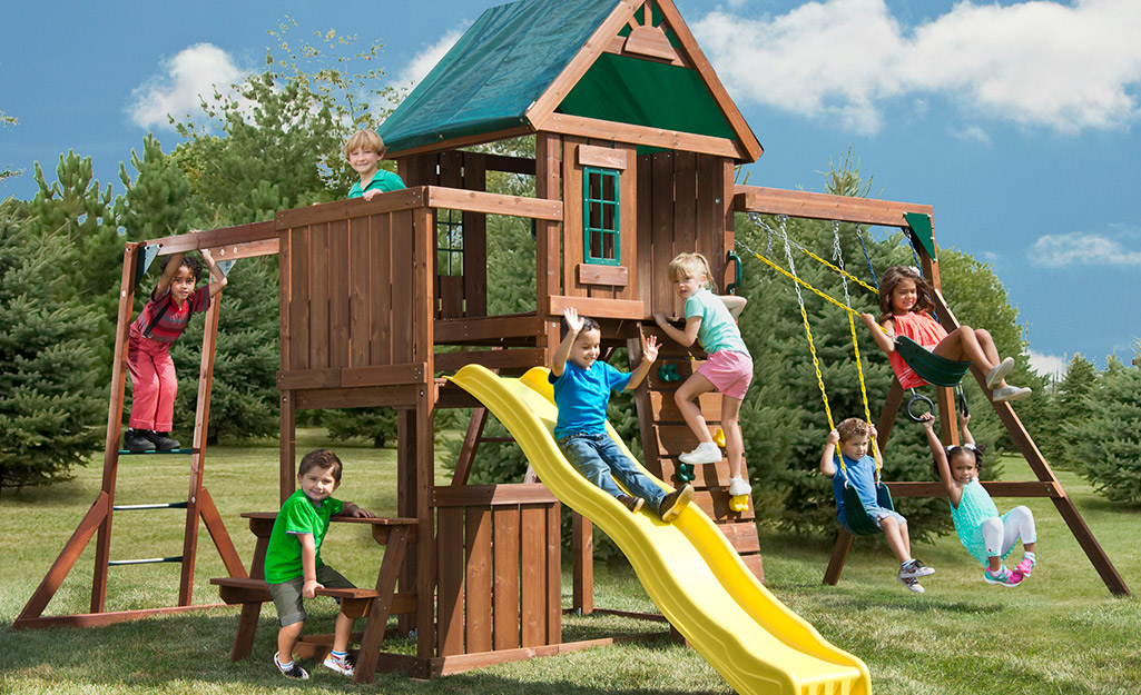 Children playing on a wooden playset.