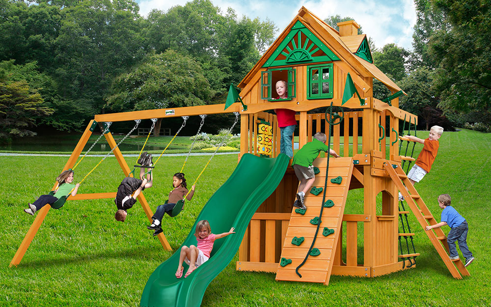 Children playing on a wood swing set.