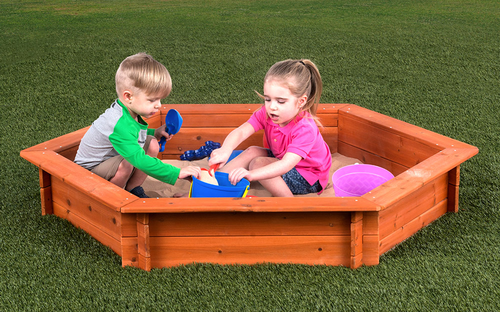 Children playing in a sandbox.