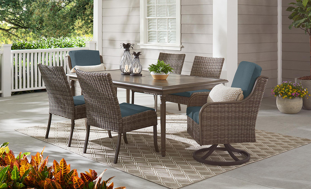 A backyard patio with an outdoor dining set.