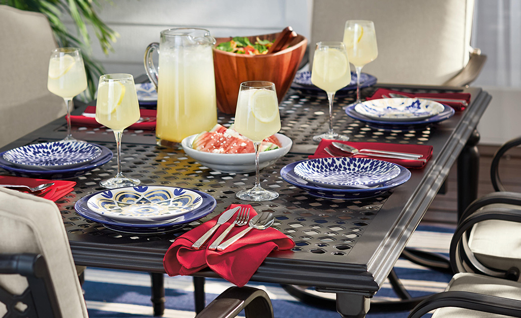 An outdoor table set for a dinner party.