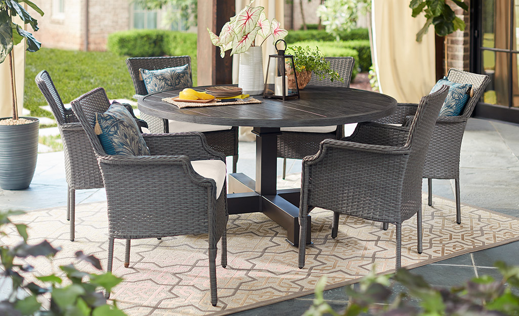 A backyard patio with an outdoor dining set