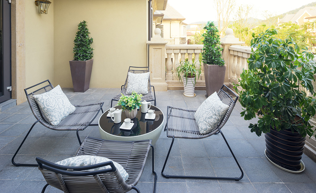 Black wire frame patio chairs surrounding a round patio table.