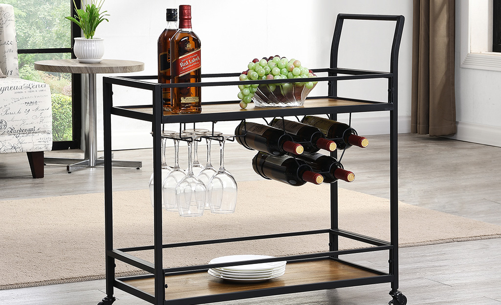 A bar cart with a built-in wine rack and under-shelf storage for stemware. A bar cart with a built-in wine rack and under-shelf storage for stemware.