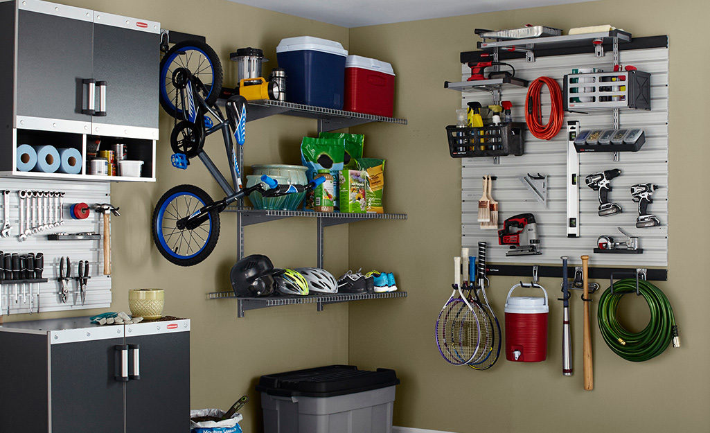 A basement wall holds a pegboard, bicycle and wall shelving.