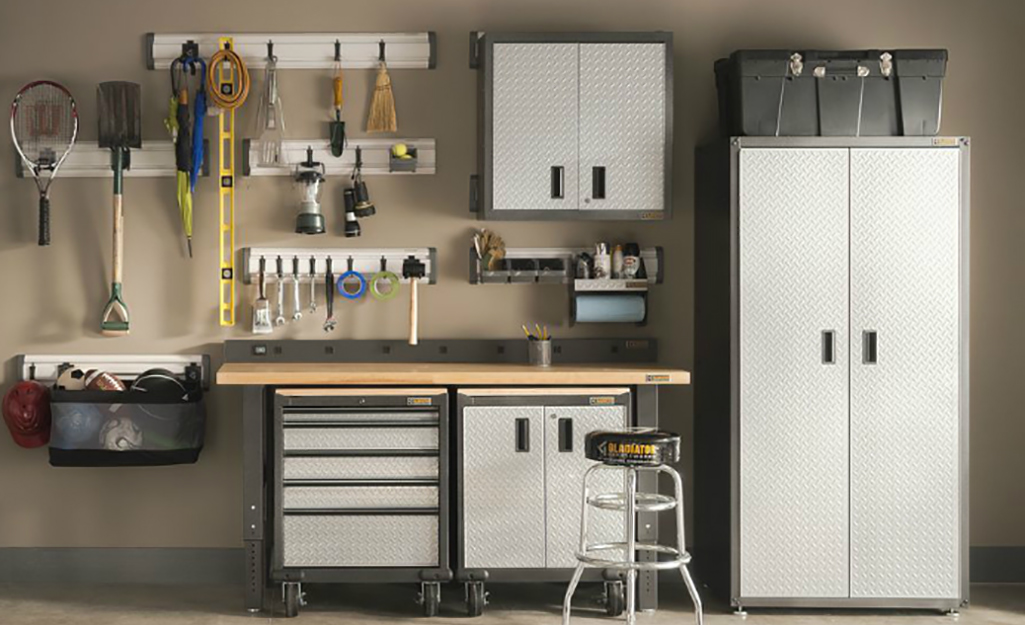 A basement corner is carved out as a workspace with tool storage and wall cabinets.
