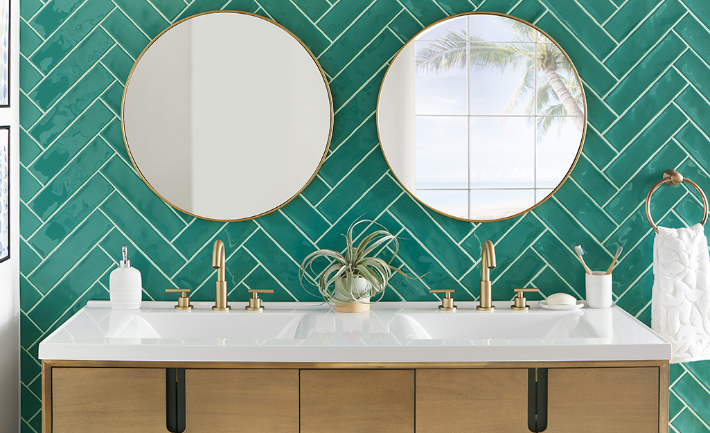 Green tiles installed behind double vanity mirrors. Green tiles installed behind double vanity mirrors.