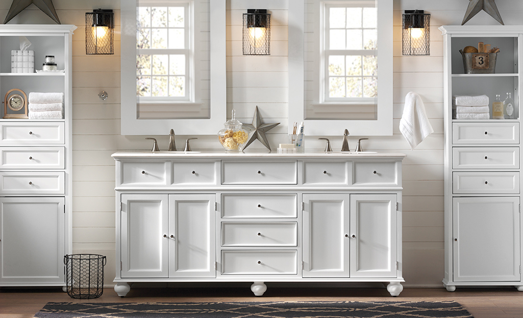 A paneled double vanity installed under two square mirrors.. A paneled double vanity installed under two square mirrors..