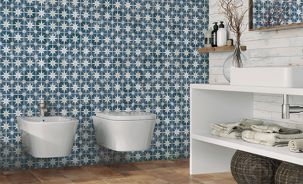 Flowered blue and white tile installed on a bath wall. Flowered blue and white tile installed on a bath wall.