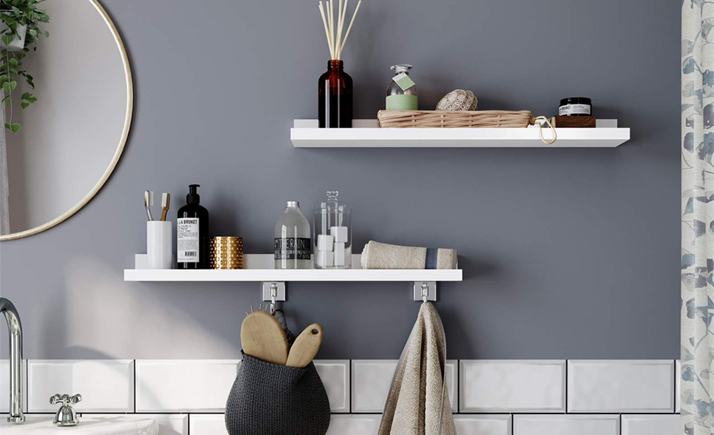 A bathroom wall featuring free floating storage shelves.