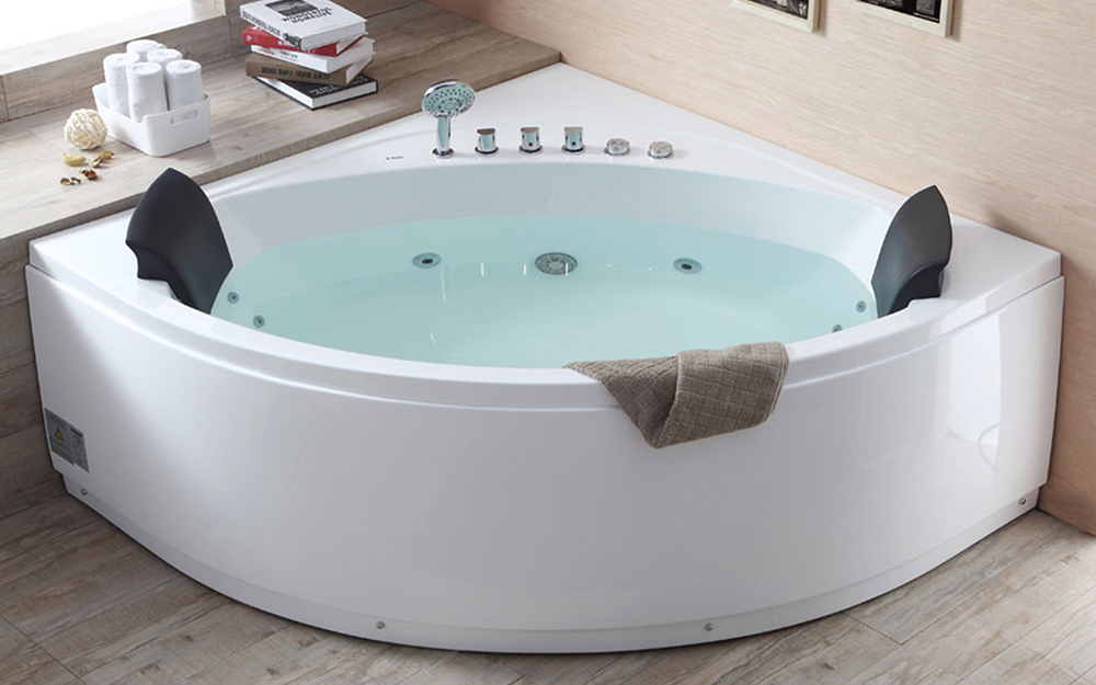 A blue shower curtain hanging over a white tub.