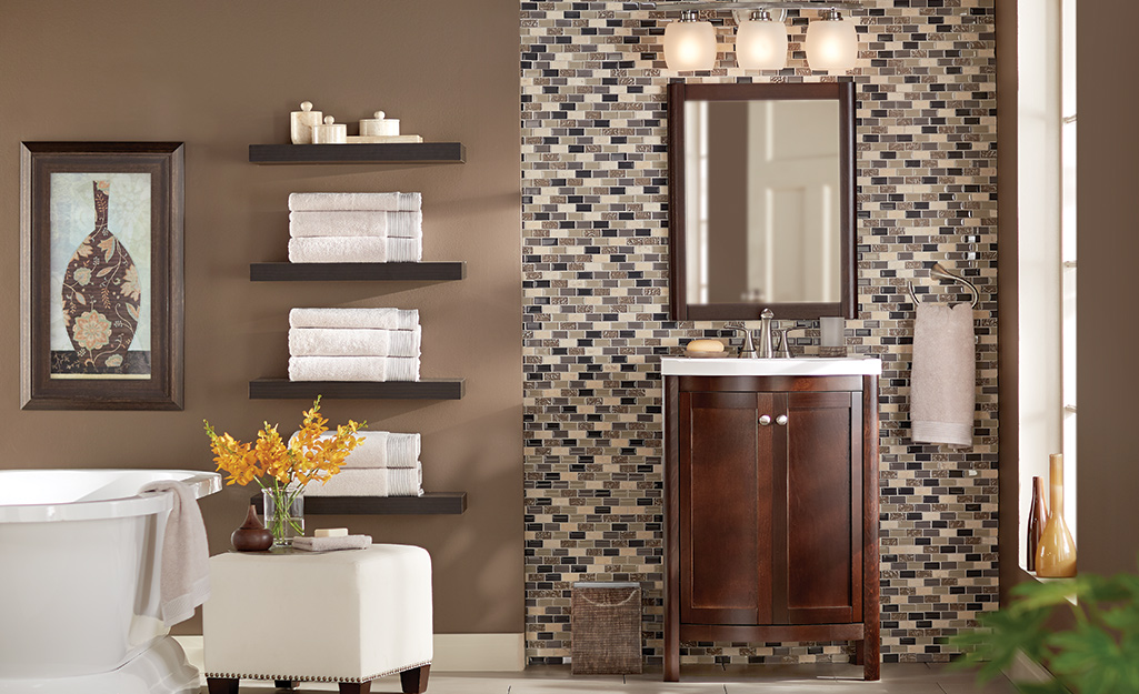 A bathroom with various wall decor pieces.