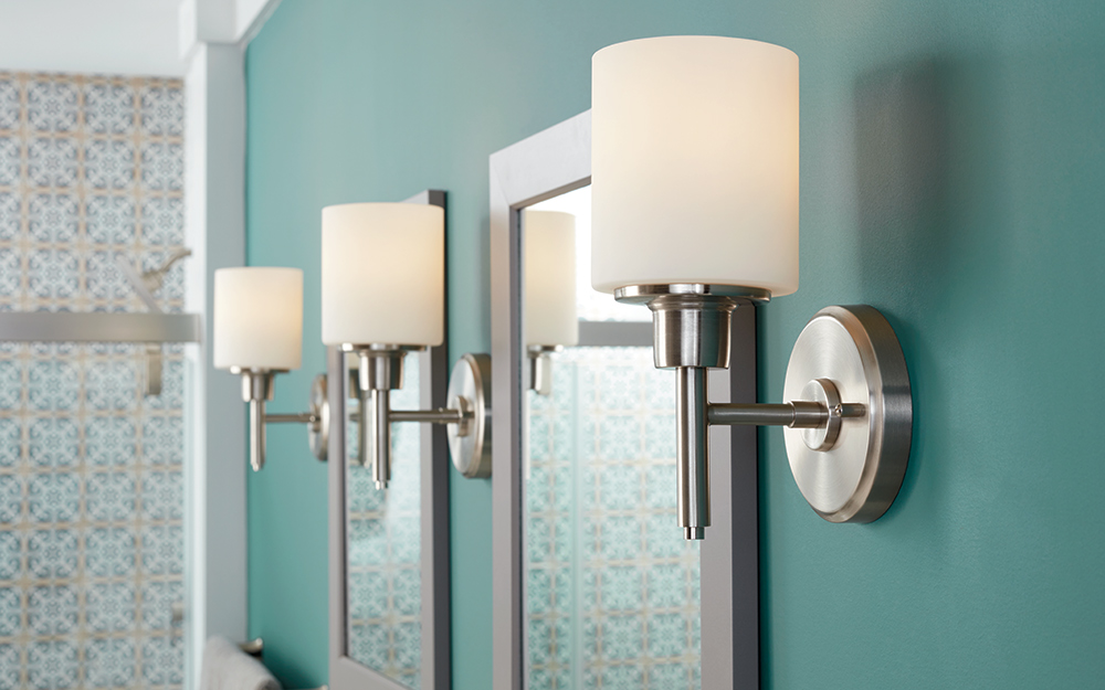 Bright lighting fixtures in a blue bathroom.