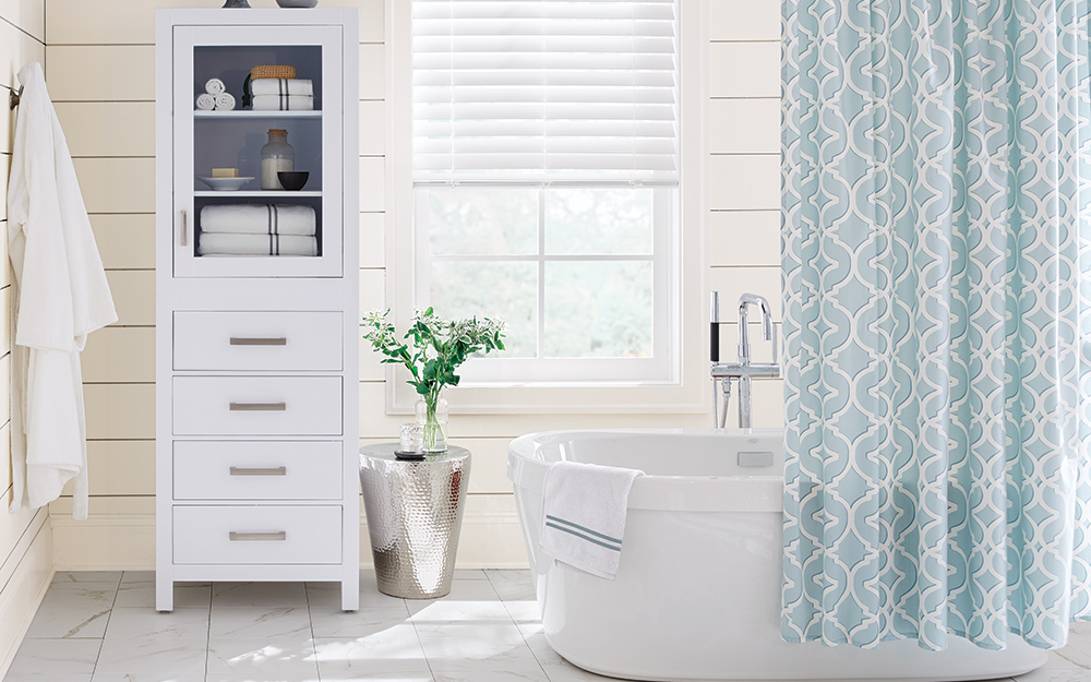 A jetted bathtub placed in the corner of a bathroom.