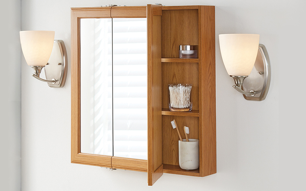 A modern medicine cabinet open to reveal toiletries.