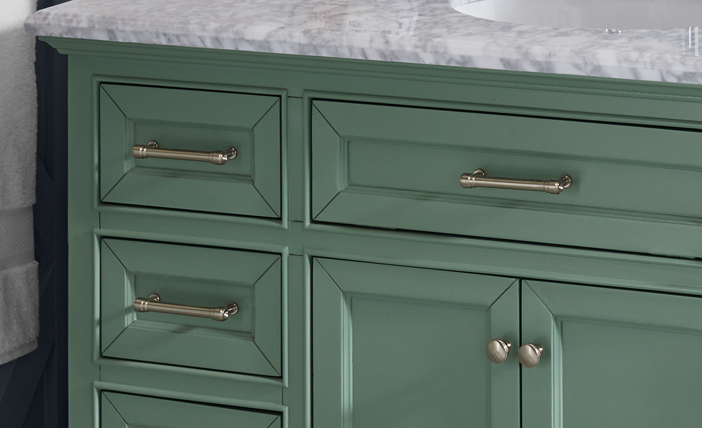 A close up of hardware on a bath vanity.