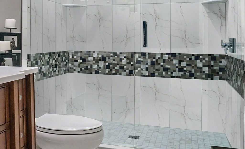 Oversized tiles line a shower wall.