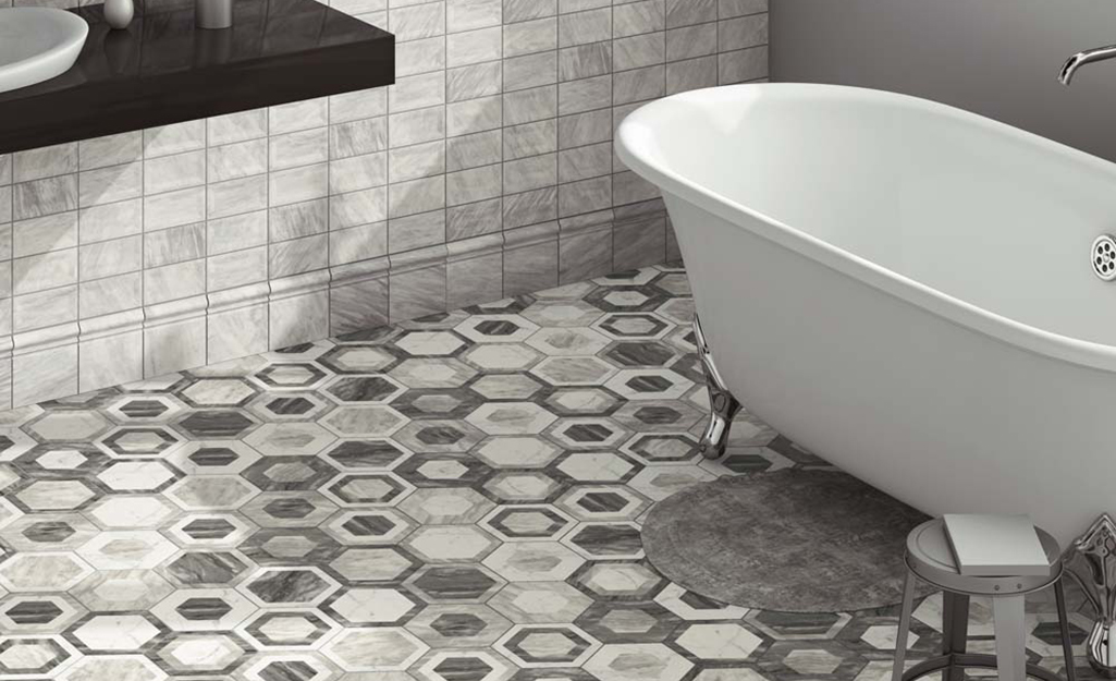 Bathroom floor tiles in a gray and white octagon pattern mosaic.