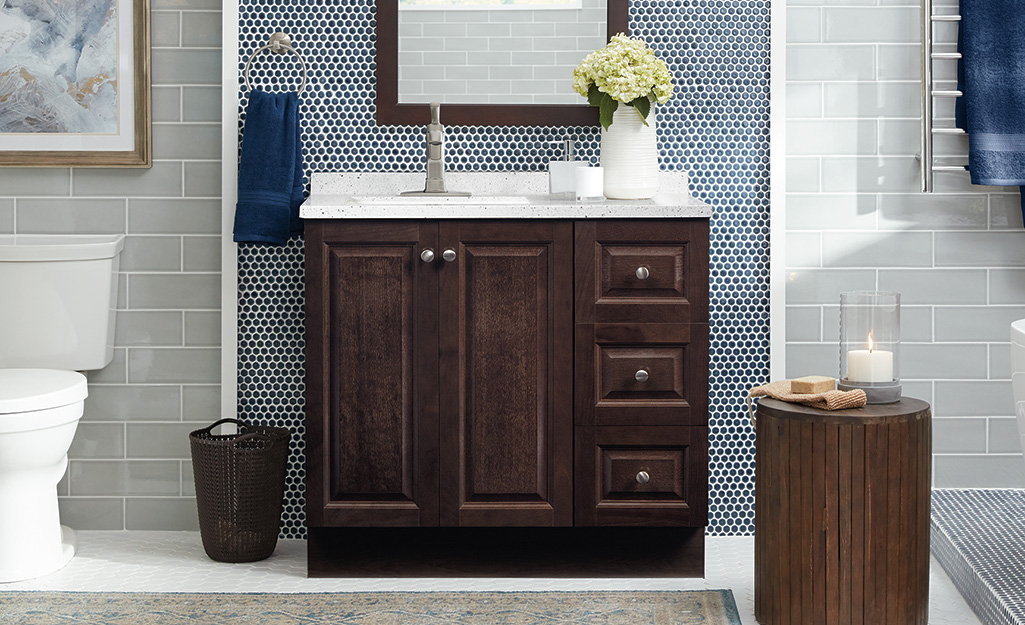 A brown cabinet vanity with a door and two drawers.