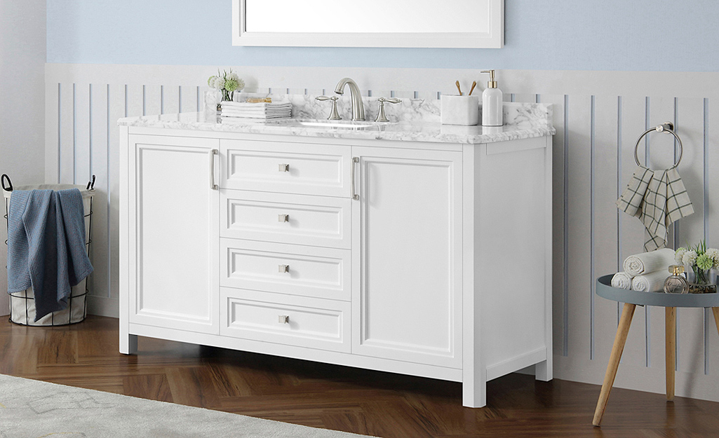 A white bathroom vanity with a spacious granite countertop.