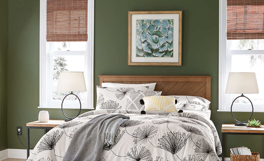 Bedroom with green walls and wood accents. 