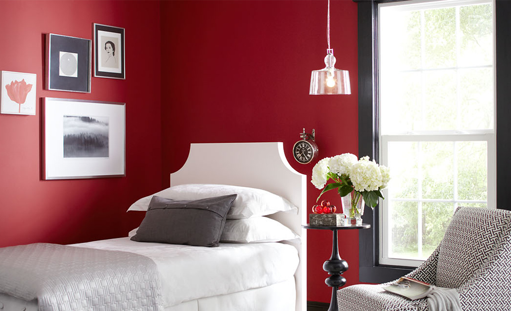 Bedroom with a deep red wall. 